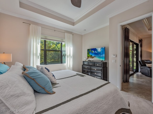 bedroom with crown molding, ceiling fan, and a raised ceiling