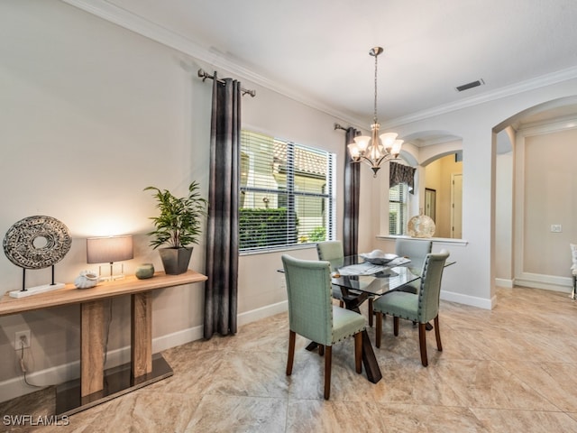 dining area with crown molding and a chandelier