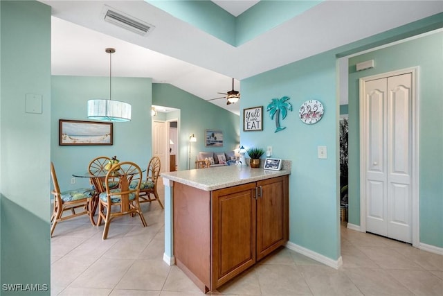 kitchen featuring ceiling fan, light tile patterned floors, pendant lighting, and kitchen peninsula