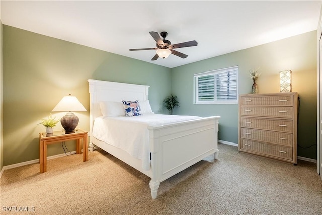 bedroom featuring light carpet and ceiling fan