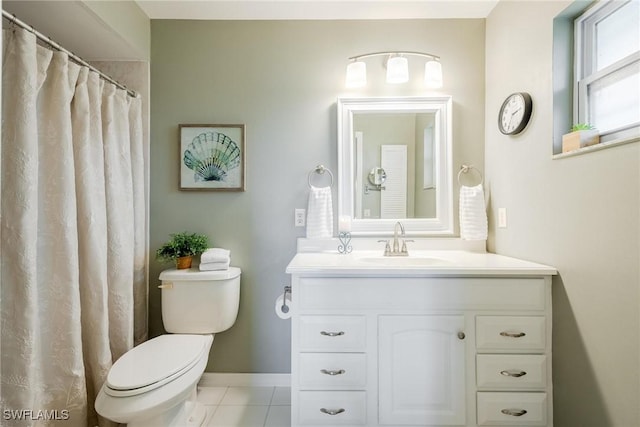 bathroom featuring toilet, tile patterned flooring, vanity, and curtained shower