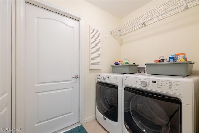 clothes washing area with washer and dryer