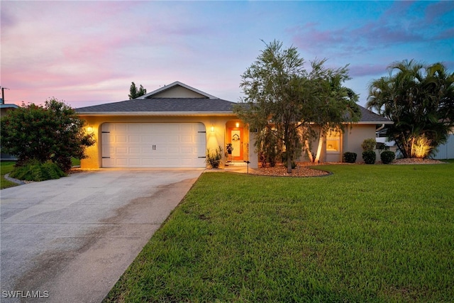 single story home with a yard and a garage