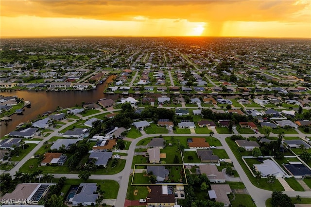 aerial view at dusk with a water view