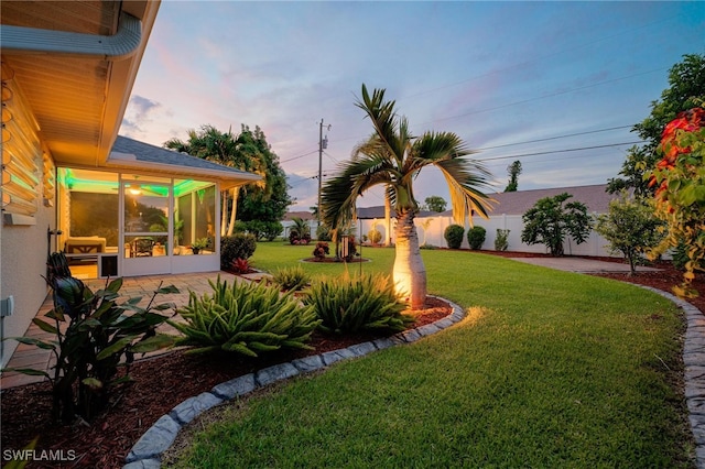 view of yard at dusk