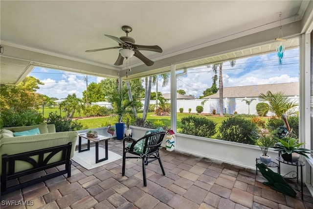 sunroom / solarium with ceiling fan and a healthy amount of sunlight