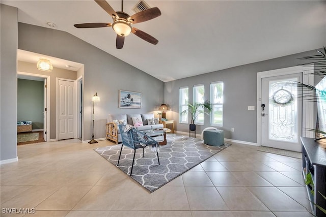 living room featuring ceiling fan, light tile patterned floors, and lofted ceiling