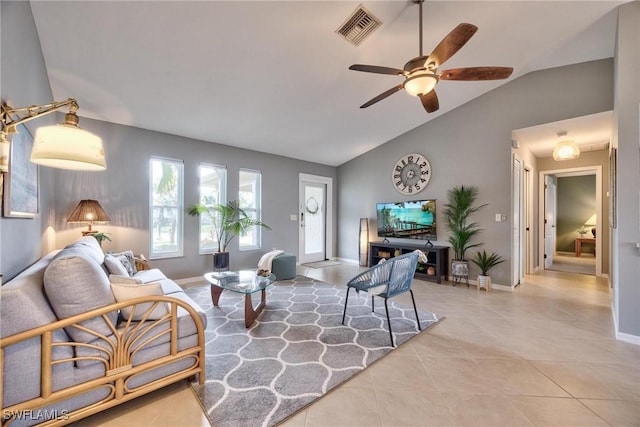 living room with ceiling fan, light tile patterned floors, and lofted ceiling