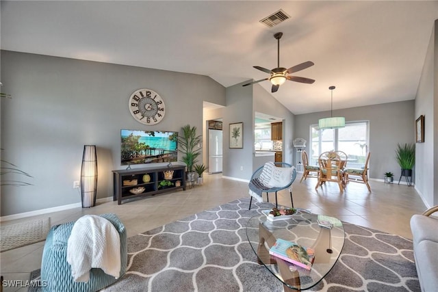 living room with ceiling fan, light tile patterned floors, and lofted ceiling