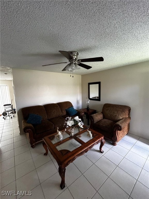 tiled living room featuring a textured ceiling and ceiling fan