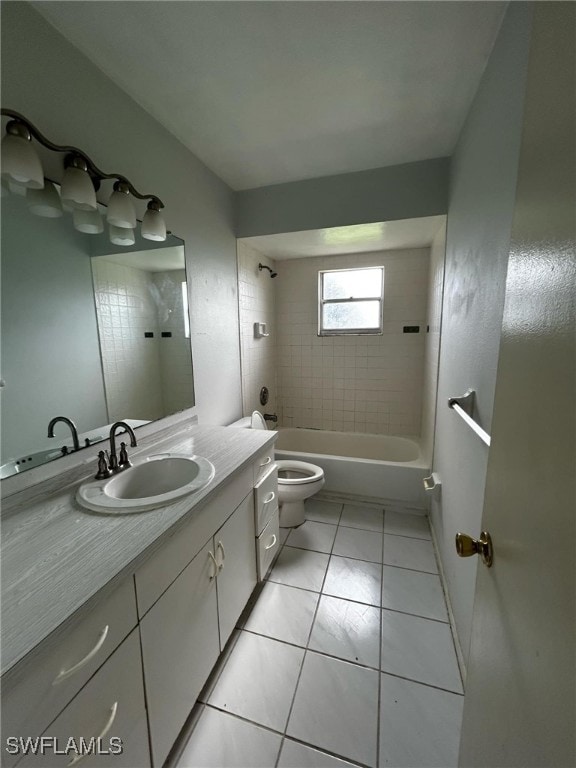 full bathroom featuring tile patterned flooring, toilet, tiled shower / bath, and vanity