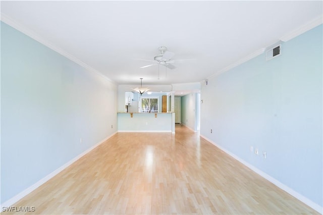 unfurnished living room with light wood finished floors, ceiling fan, ornamental molding, and baseboards