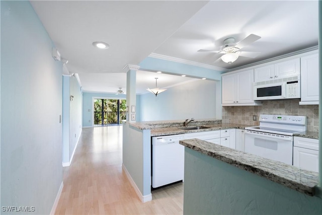 kitchen with tasteful backsplash, white appliances, white cabinets, and ornamental molding