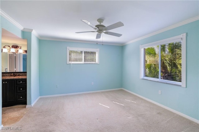 unfurnished bedroom with baseboards, multiple windows, ornamental molding, and a sink