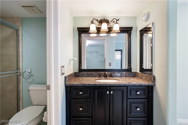 full bath with a notable chandelier, visible vents, toilet, a shower stall, and vanity