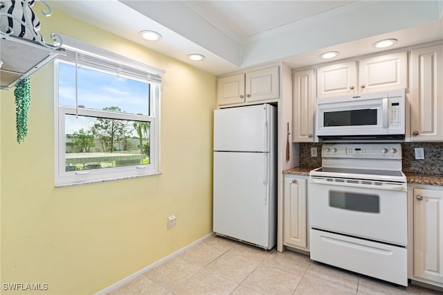 kitchen featuring dark stone counters, light tile patterned floors, crown molding, backsplash, and white appliances