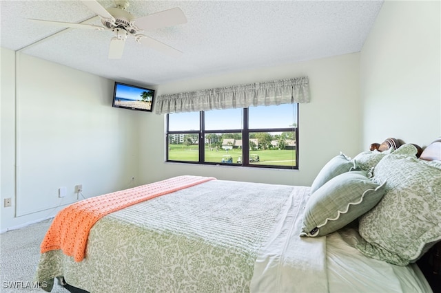 bedroom with carpet flooring, a textured ceiling, and ceiling fan