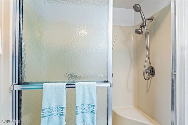 bathroom featuring a shower with door