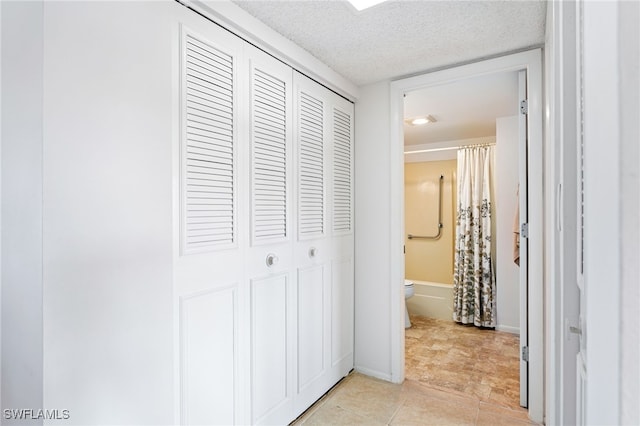 hallway featuring a textured ceiling