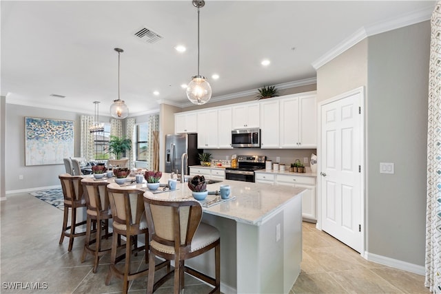 kitchen featuring a center island with sink, a kitchen bar, stainless steel appliances, light stone counters, and white cabinets