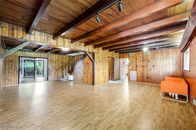 18191 Slater Rd, North Fort Myers, FL 33917 - unfurnished living room featuring beamed ceiling, wood finished floors, stairs, wood ceiling, and wooden walls
