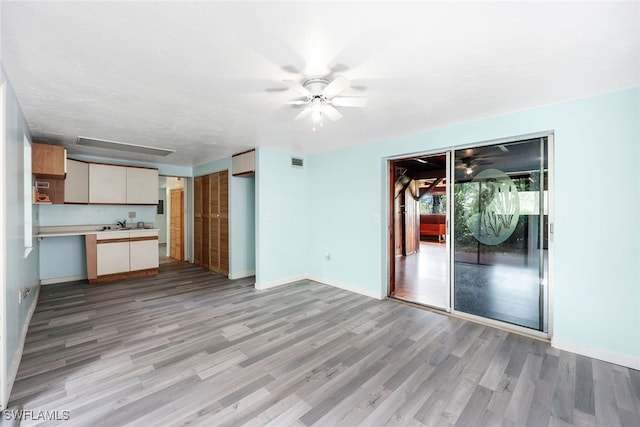 18191 Slater Rd, North Fort Myers, FL 33917 - unfurnished living room featuring light wood finished floors, a ceiling fan, baseboards, and visible vents