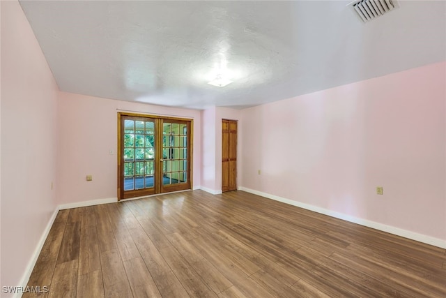 18191 Slater Rd, North Fort Myers, FL 33917 - spare room with baseboards, hardwood / wood-style flooring, and visible vents