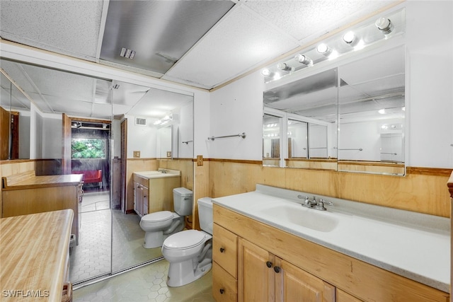 18191 Slater Rd, North Fort Myers, FL 33917 - full bath with a wainscoted wall, wooden walls, visible vents, toilet, and vanity
