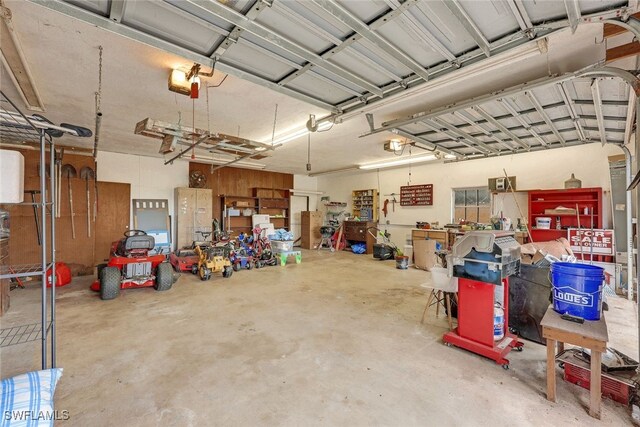 18191 Slater Rd, North Fort Myers, FL 33917 - garage with a workshop area and a garage door opener
