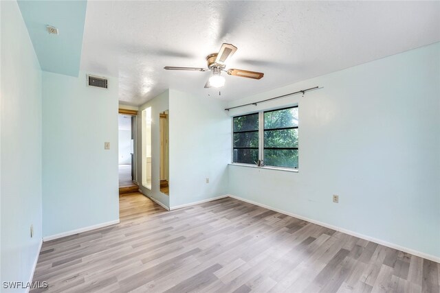 18191 Slater Rd, North Fort Myers, FL 33917 - unfurnished room with visible vents, light wood finished floors, baseboards, and ceiling fan