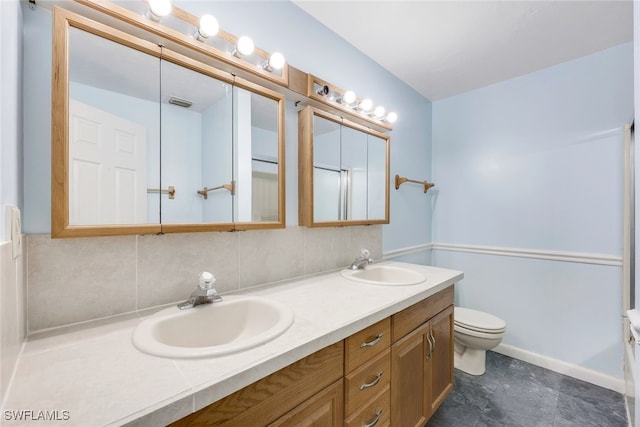 18191 Slater Rd, North Fort Myers, FL 33917 - bathroom featuring decorative backsplash, a sink, double vanity, and toilet
