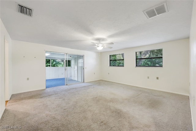 18191 Slater Rd, North Fort Myers, FL 33917 - carpeted empty room featuring visible vents, a wealth of natural light, and ceiling fan