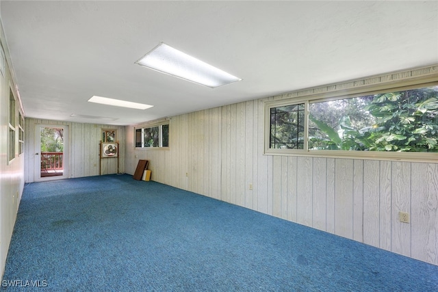 18191 Slater Rd, North Fort Myers, FL 33917 - empty room featuring wood walls and carpet flooring