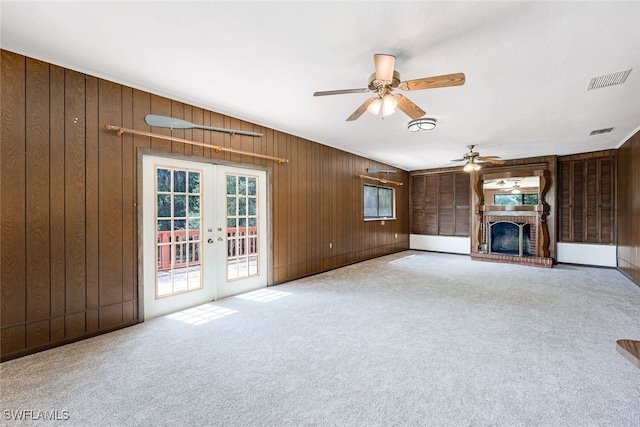 18191 Slater Rd, North Fort Myers, FL 33917 - unfurnished living room featuring french doors, a brick fireplace, carpet floors, and ceiling fan