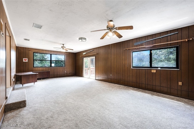 18191 Slater Rd, North Fort Myers, FL 33917 - spare room featuring wooden walls, carpet floors, a ceiling fan, and visible vents