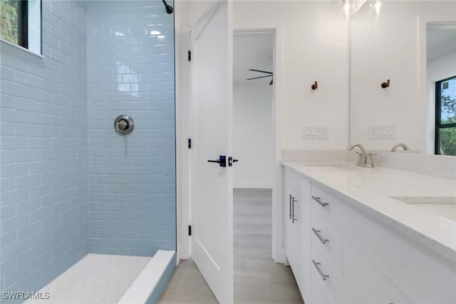 bathroom featuring ceiling fan, plenty of natural light, vanity, and hardwood / wood-style floors