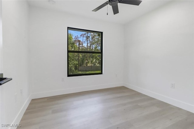 empty room with ceiling fan and light wood-type flooring