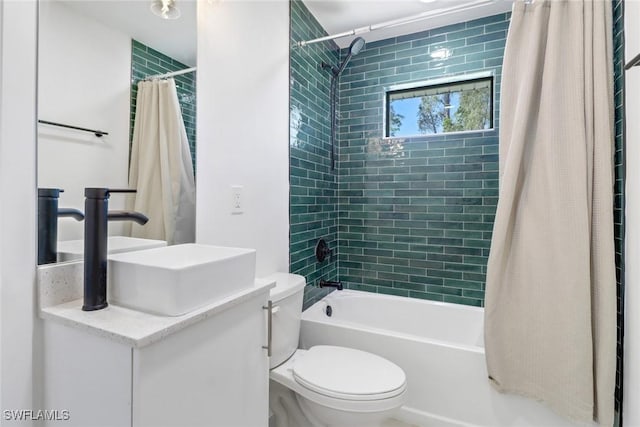 full bathroom with sink, shower / bathtub combination with curtain, and toilet