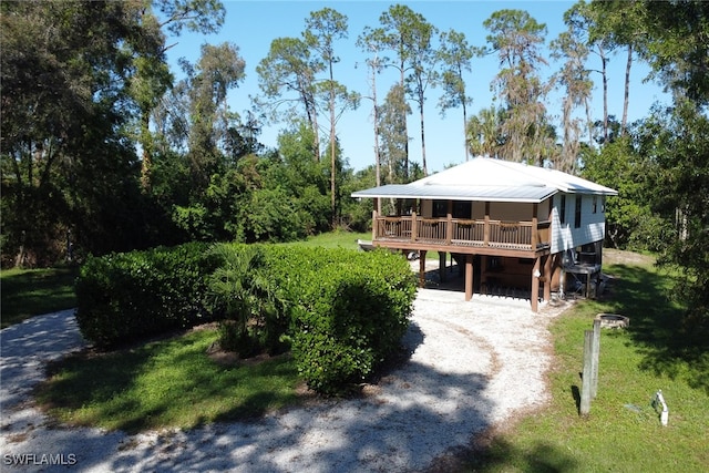 view of front of home with a carport and a wooden deck