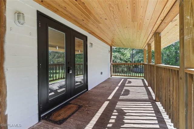 wooden terrace featuring french doors and covered porch