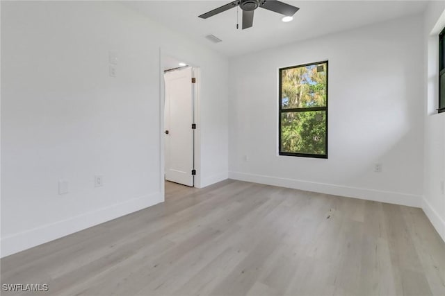 spare room featuring ceiling fan and light hardwood / wood-style floors