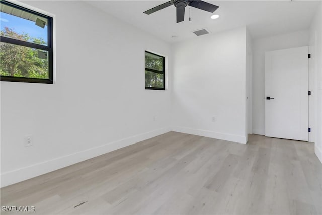 empty room featuring ceiling fan and light wood-type flooring