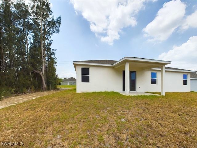 rear view of house with a yard