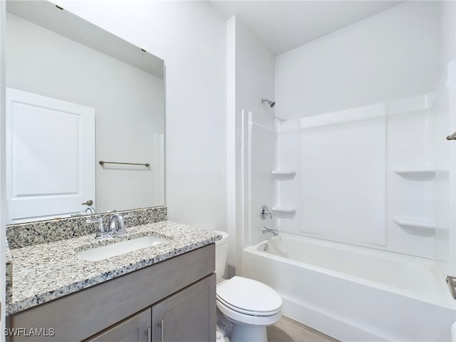 full bathroom featuring vanity, toilet, hardwood / wood-style flooring, and  shower combination