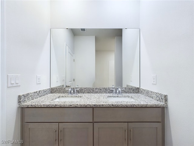 bathroom with dual bowl vanity