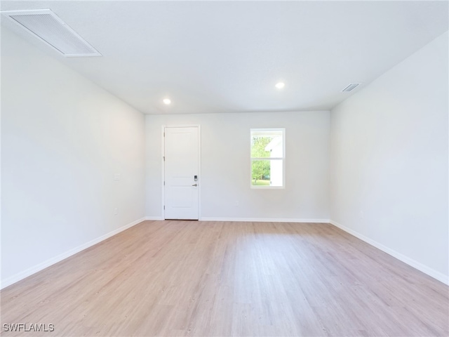 spare room with light hardwood / wood-style flooring