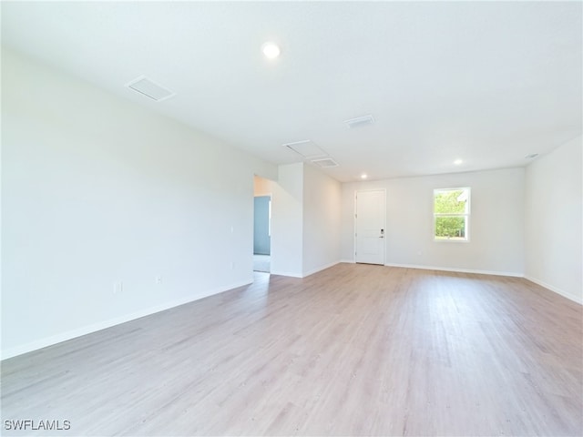 spare room with light hardwood / wood-style floors