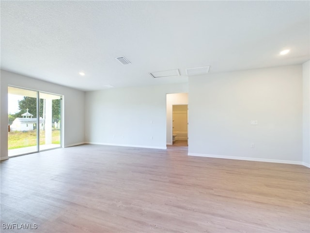 spare room with light hardwood / wood-style floors