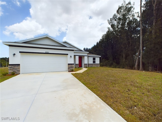 view of front of property with a garage and a front lawn