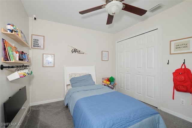 carpeted bedroom featuring ceiling fan and a closet